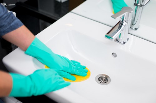 Worker using protective equipment during cleaning tasks